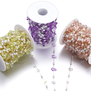 Close-up of irregular crushed stone and pearl chain reels for DIY jewelry making