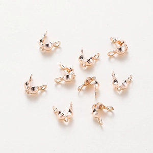 Close-up of rose gold plated fold-over end crimps with double loops for DIY jewelry making