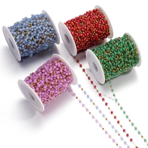 Close-up of cat eye glass bead chain in light blue, dark red, green, and purple