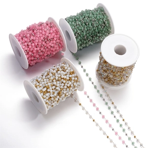 Close-up of colorful cat eye glass bead chains in pink, green, white, and iridescent hues
