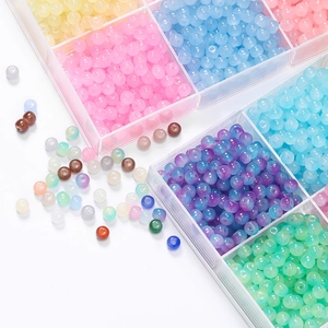 Macro detail of mixed candy color apple beads in clear plastic organizer for DIY jewelry