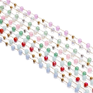 Close-up of colorful cat-eye glass beads on fine stainless steel chain for DIY jewelry