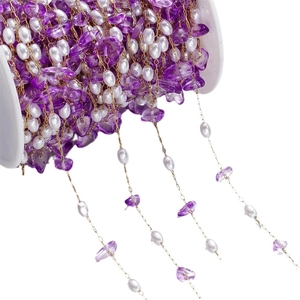 DIY golden stainless steel chain with purple stones and pearls on white spool