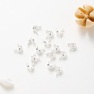 Macro view of polished rose gold plated double fold bead tips for DIY jewelry making