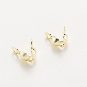 Macro view of rose gold plated bead tips for DIY handmade jewelry finishing and connections
