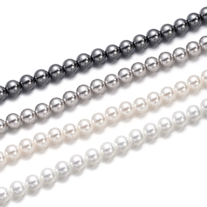 Detailed view of 3-12mm round glass pearls in dark grey, silver, cream, and white finishes