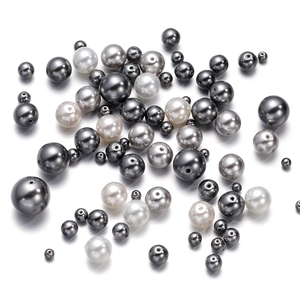 Macro shot of assorted size metallic grey and silver glass pearls for DIY jewelry making