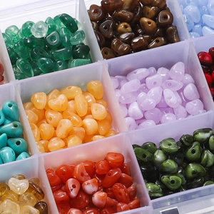 Macro detail of 15 compartments filled with irregular acrylic stone beads for DIY jewelry
