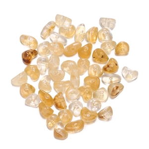 Detailed view of translucent amber heart-shaped acrylic beads with pre-drilled holes
