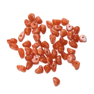 Macro detail of irregular 10mm orange agate beads with pre-drilled holes for DIY jewelry