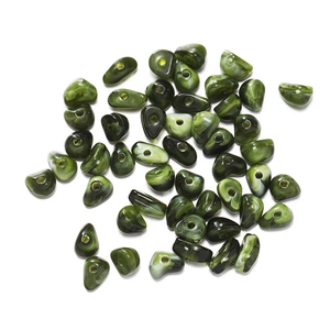 Macro view of dark green irregular crushed stone beads with natural marbled texture