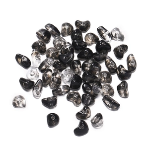 Macro shot of irregular smoky grey acrylic stone beads with precise heart-shaped holes