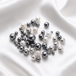 Macro shot of 3-12mm polished white and grey glass pearl beads for DIY jewelry making