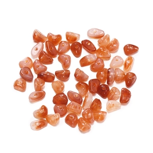 Detail of irregular orange-red carnelian stone beads with pre-drilled holes for jewelry DIY