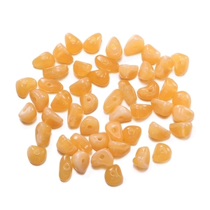 Macro detail of irregular orange acrylic stone beads for DIY jewelry making sets