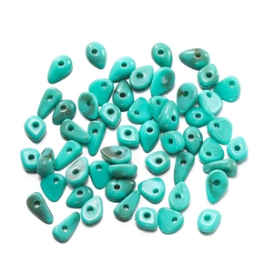 Macro detail of turquoise teardrop beads with marble texture for DIY jewelry making