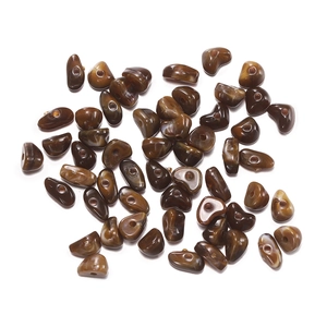 Close-up of irregular brown acrylic beads with marble texture for DIY jewelry making