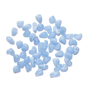 Close-up of light blue irregular acrylic beads with natural cloudy texture for DIY