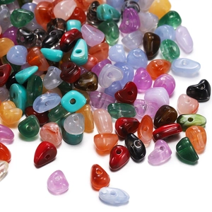 Macro shot of 15-grid acrylic stone beads set with heart and waterdrop shapes for DIY crafts