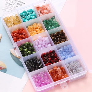Flat lay of 15-grid organizer box with multi-color heart-shaped faux stone beads for DIY