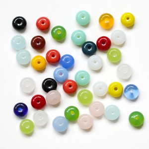 Macro shot of assorted colorful flat round glass spacer beads for DIY jewelry making
