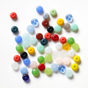 Close-up of mixed candy-colored flat glass beads for DIY handicraft and jewelry making