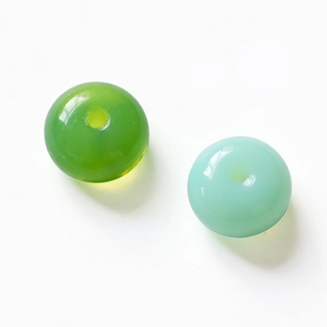 Macro detail of candy-colored glass abacus beads with a polished smooth finish