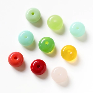 Macro view of assorted colorful glass beads with smooth finish and central holes for DIY jewelry
