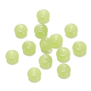 Close-up of translucent light green glass beads with 1.5mm holes for DIY jewelry making