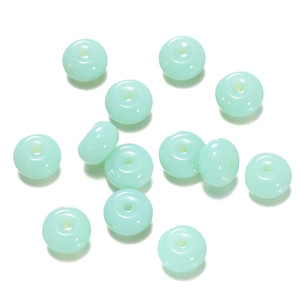 Detailed macro view of mint green translucent glass abacus beads for DIY crafts