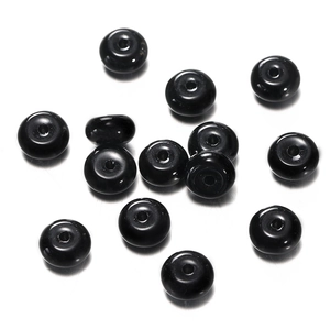 Close-up of polished black flat round glass beads for DIY jewelry making and crafts