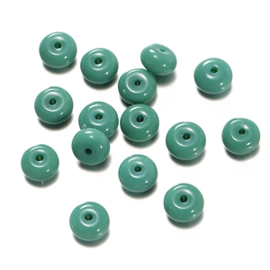 Detailed close-up of emerald green polished glass beads for DIY jewelry making and crafts