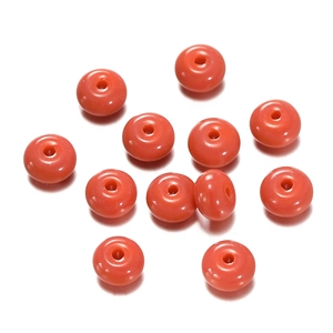 Macro view of bright coral orange abacus glass beads for DIY jewelry making