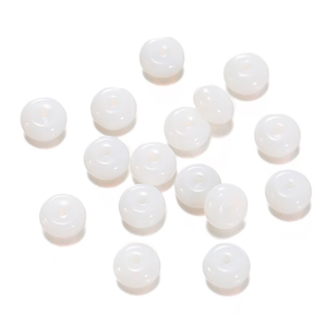 Close-up of translucent white donut-shaped glass beads for DIY jewelry making and crafts