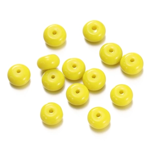 Macro detail of 1.5mm hole lemon yellow glass abacus beads for DIY jewelry making