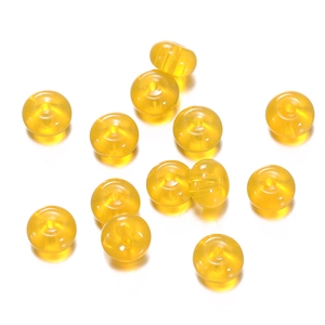 Macro detail of twelve translucent yellow flat round glass beads for DIY jewelry making