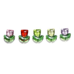 Detailed view of colorful translucent tulip beads with green leaf bases for DIY jewelry