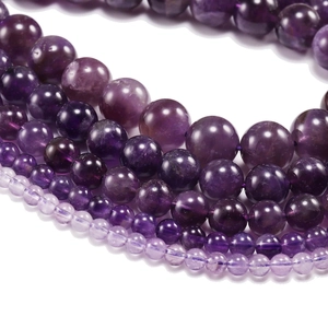 Macro shot of natural purple amethyst beads in various sizes from 4mm to 12mm
