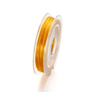 Close-up of 0.8mm yellow crystal elastic cord on a transparent spool for DIY jewelry
