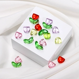Macro shot of colorful tulip acrylic flower beads with green leaves for DIY jewelry making