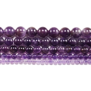 Natural purple amethyst round loose beads in five different sizes on white background