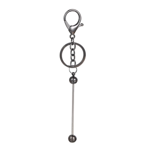 Detailed view of dark grey metal keychain with lobster clasp and vertical pendant bar