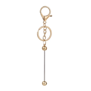 Detailed view of golden lobster clasp and flat key ring with metallic bead bar