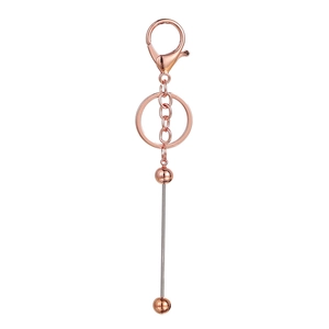 Close-up of rose gold DIY beaded keychain components with lobster clasp and metal rod