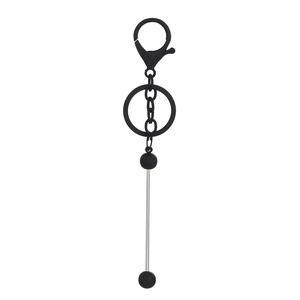 Detail of minimalist industrial black lobster clasp keychain with silver barbell pendant