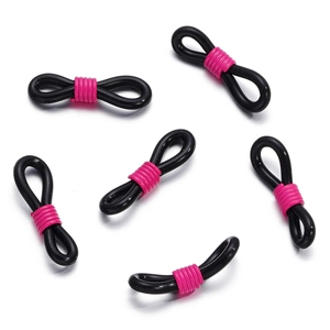 Macro detail of 6pcs black silicone 8-shaped non-slip connectors with pink sliders