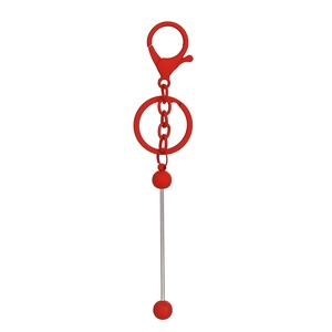 Close-up of bright red lacquered metal keychain with alloy lobster clasp and beads