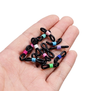 Close-up of colorful metal spring buckles and black silicone eyeglass chain connectors