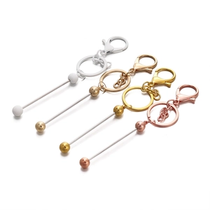 Detail of DIY keychain hardware kit featuring lobster clasps and metal bead rods in 4 colors