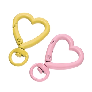 Dettagli macro di anelli a molla a cuore gialli e rosa con chiusura a moschettone